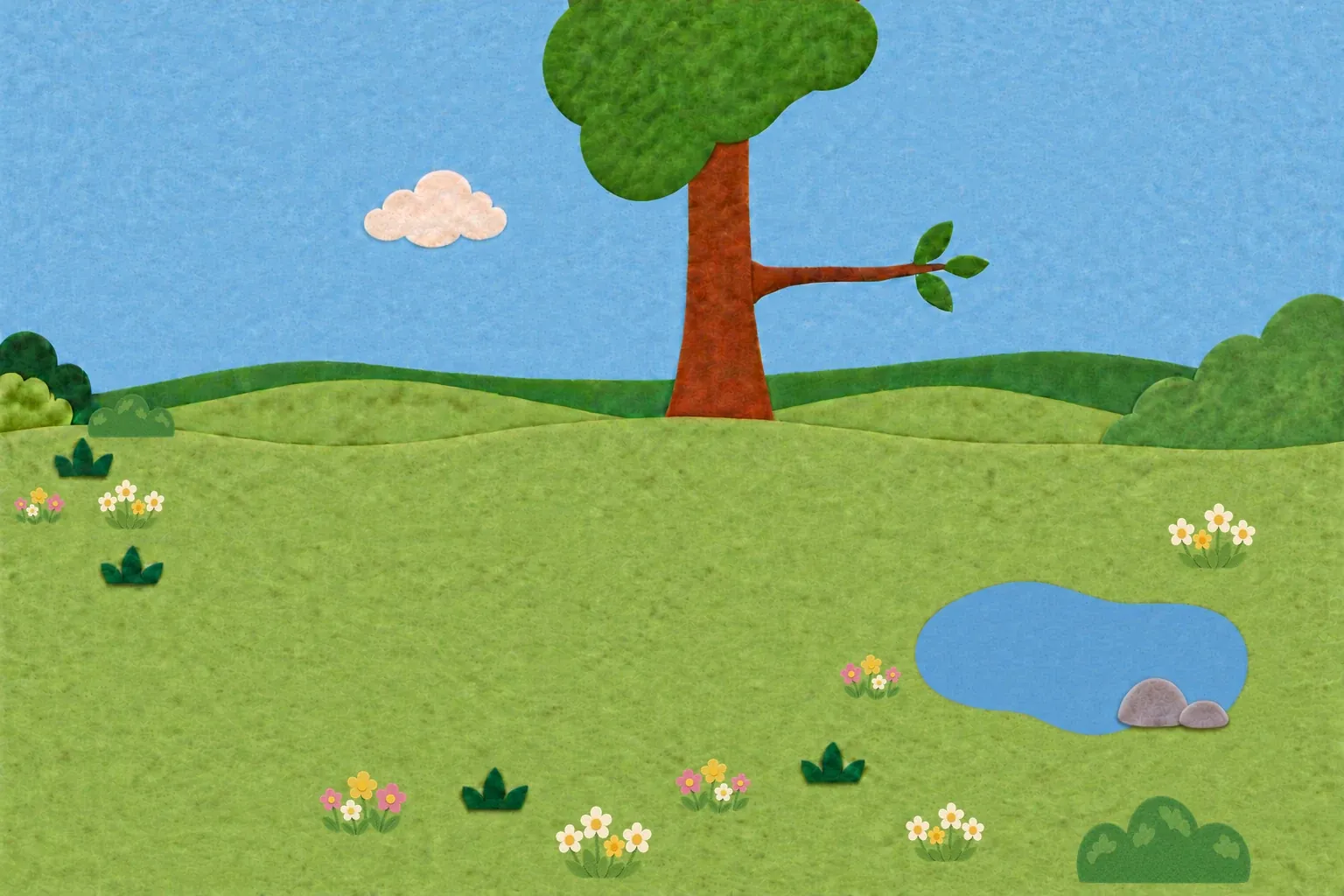 A felt meadow with a tree, flowers and a little pond, with Miś the bear and an orange cat standing in it.